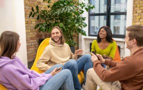 youth-pastime-group-of-young-leaders-in-jeans-and-sweaters-communicating-having-fun-sitting-in-armchairs-in-office-recreation-area070758.jpg